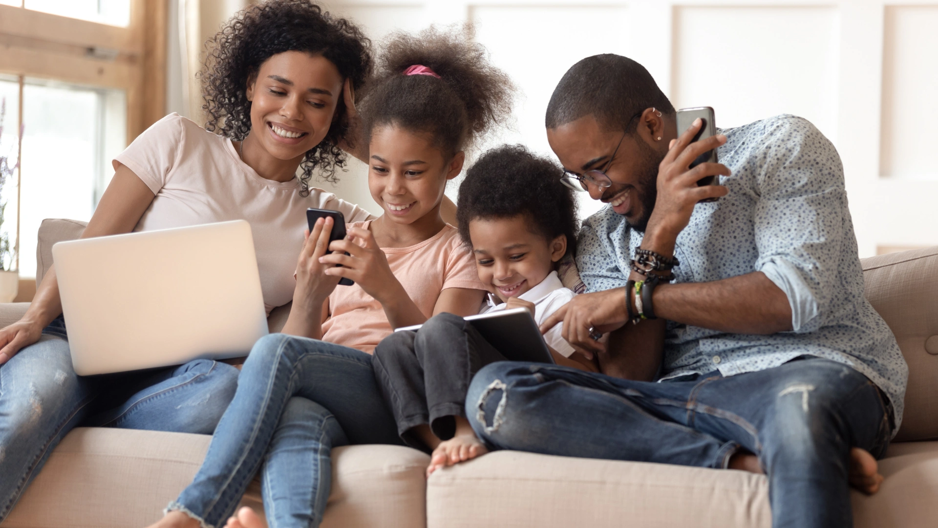 Family relaxing together on a couch in their clean Wesley Chapel home