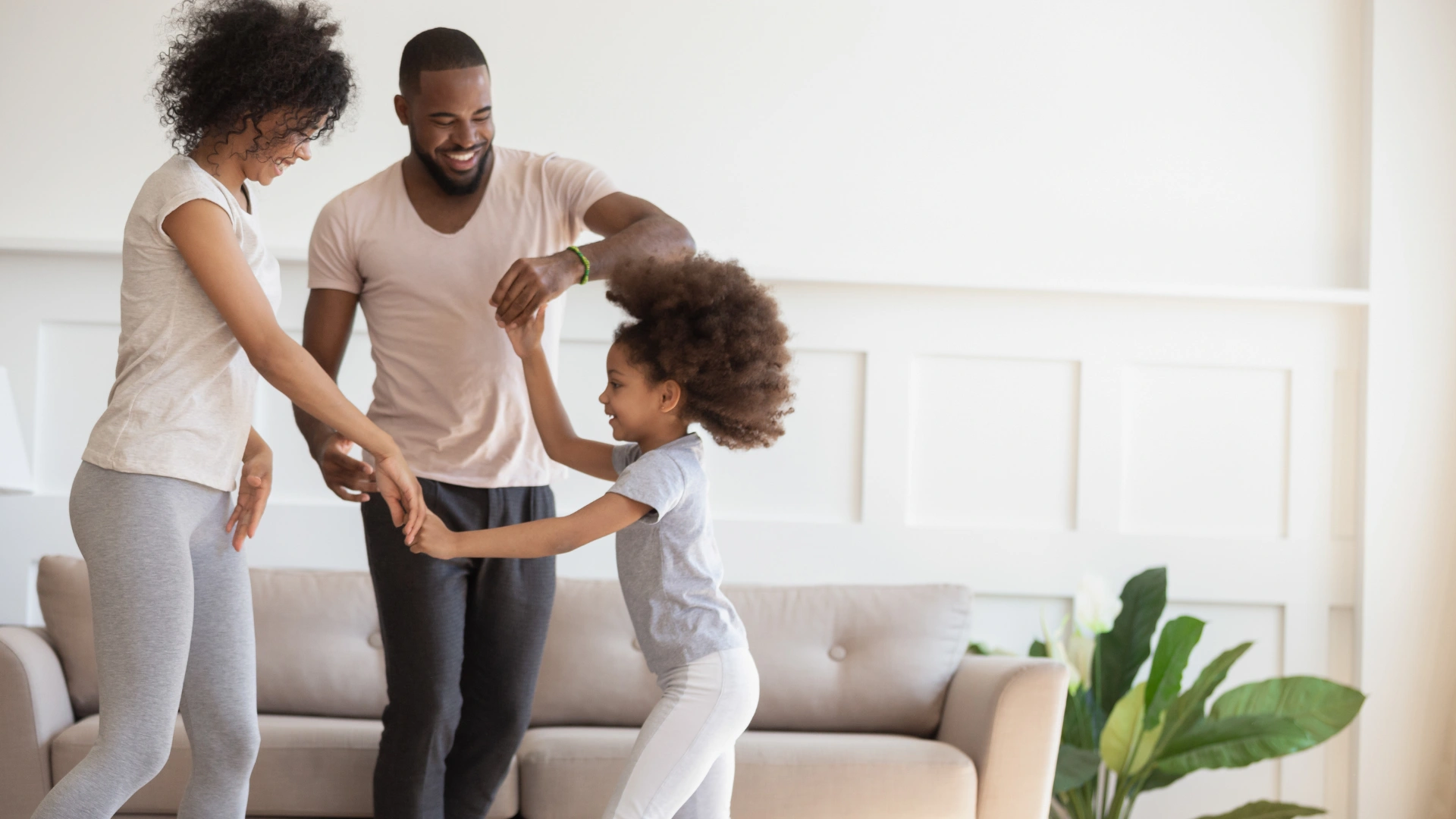 Family dancing together in their clean Wesley Chapel living room