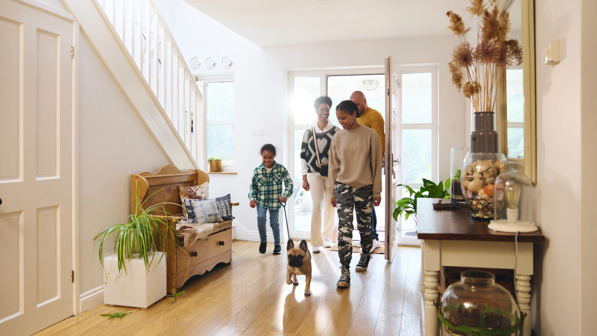 Family walking into their clean Spring Hill home with their dog