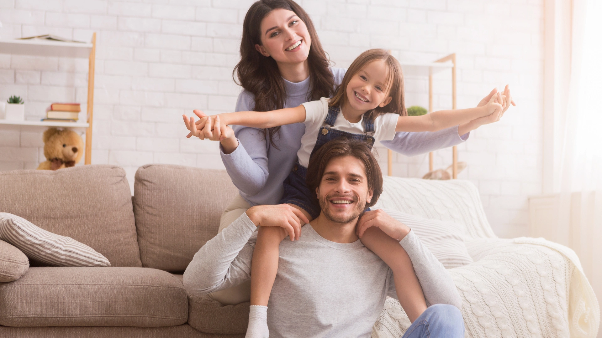 Young family playing together by the couch in a clean Lutz Florida home