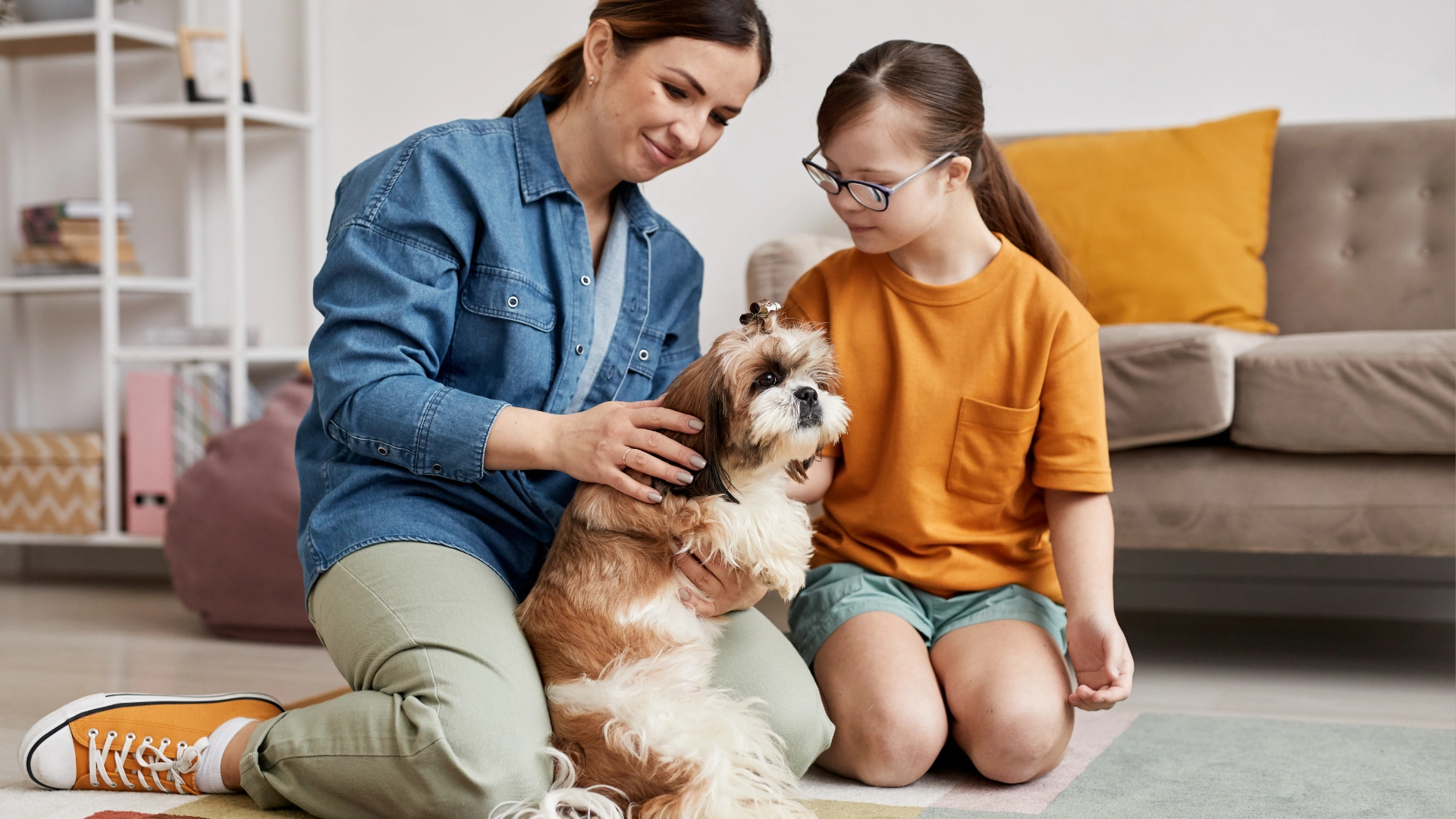 Mom and daughter sitting on clean floor with their dog in a Spring Hill home
