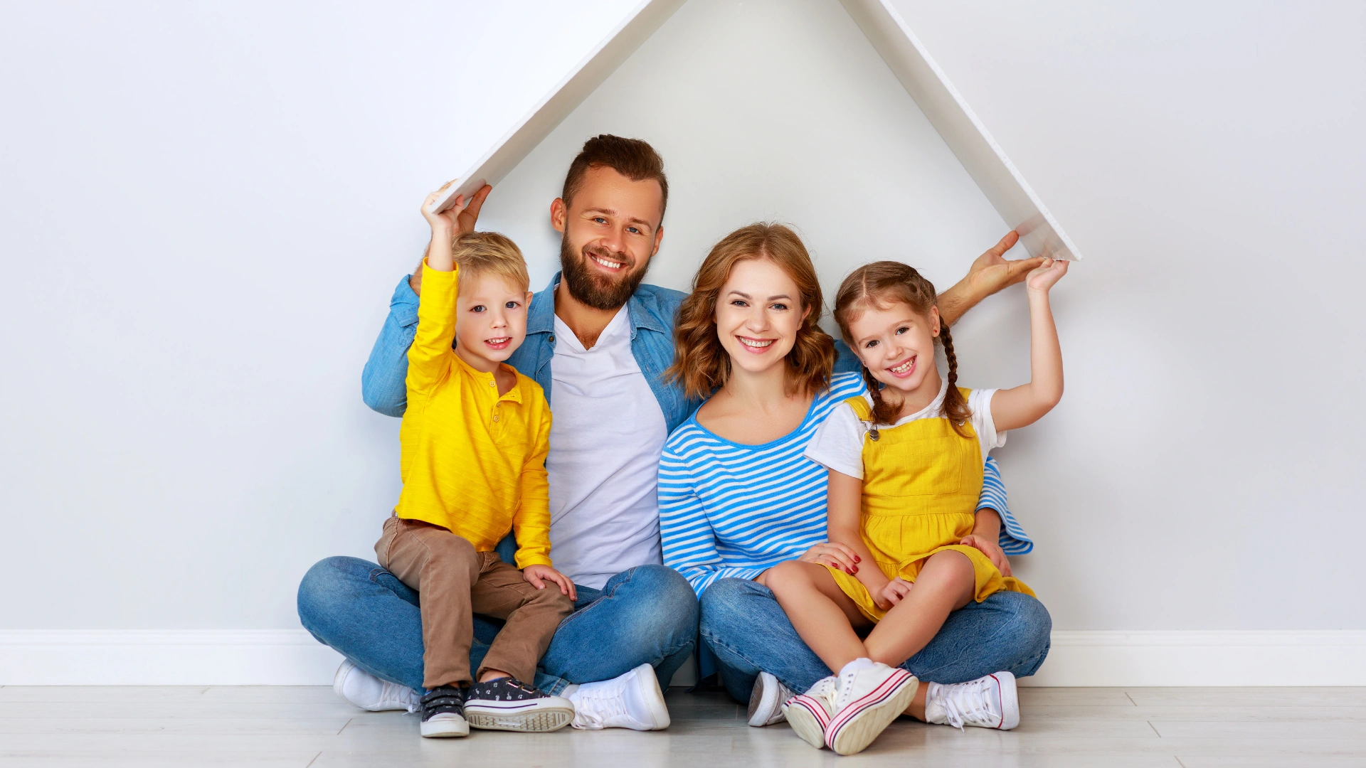 Happy family of four sitting together under a roof frame in their clean New Tampa home